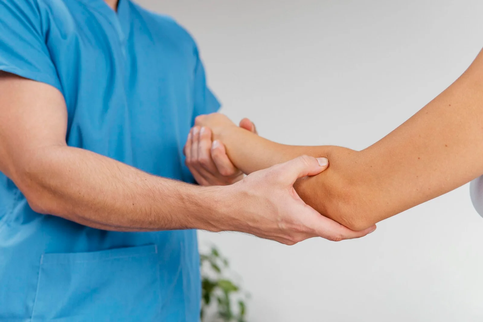 66e6a207942c7-side-view-male-osteopathic-therapist-checking-female-patient-s-elbow-joint-movement-2048x1365.jpg
